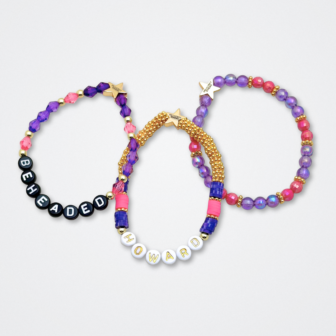 Broadway Stacks QUEEN collection. Stretch bracelets included in Stack. Gold, yellow, green, white, red, pink and blue colored beads. Letter beads that spell each queen. Also Herstory collection. Broadway Stacks gold star logo bead to remind you that You Shine. SIX the Musical fans.