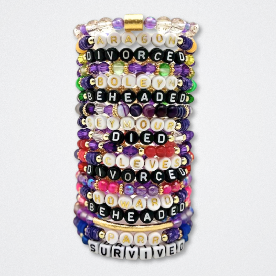 Broadway Stacks QUEEN collection. Stretch bracelets included in Stack. Gold, yellow, green, white, red, pink and blue colored beads. Letter beads that spell each queen. Also Herstory collection. Broadway Stacks gold star logo bead to remind you that You Shine. SIX the Musical fans.