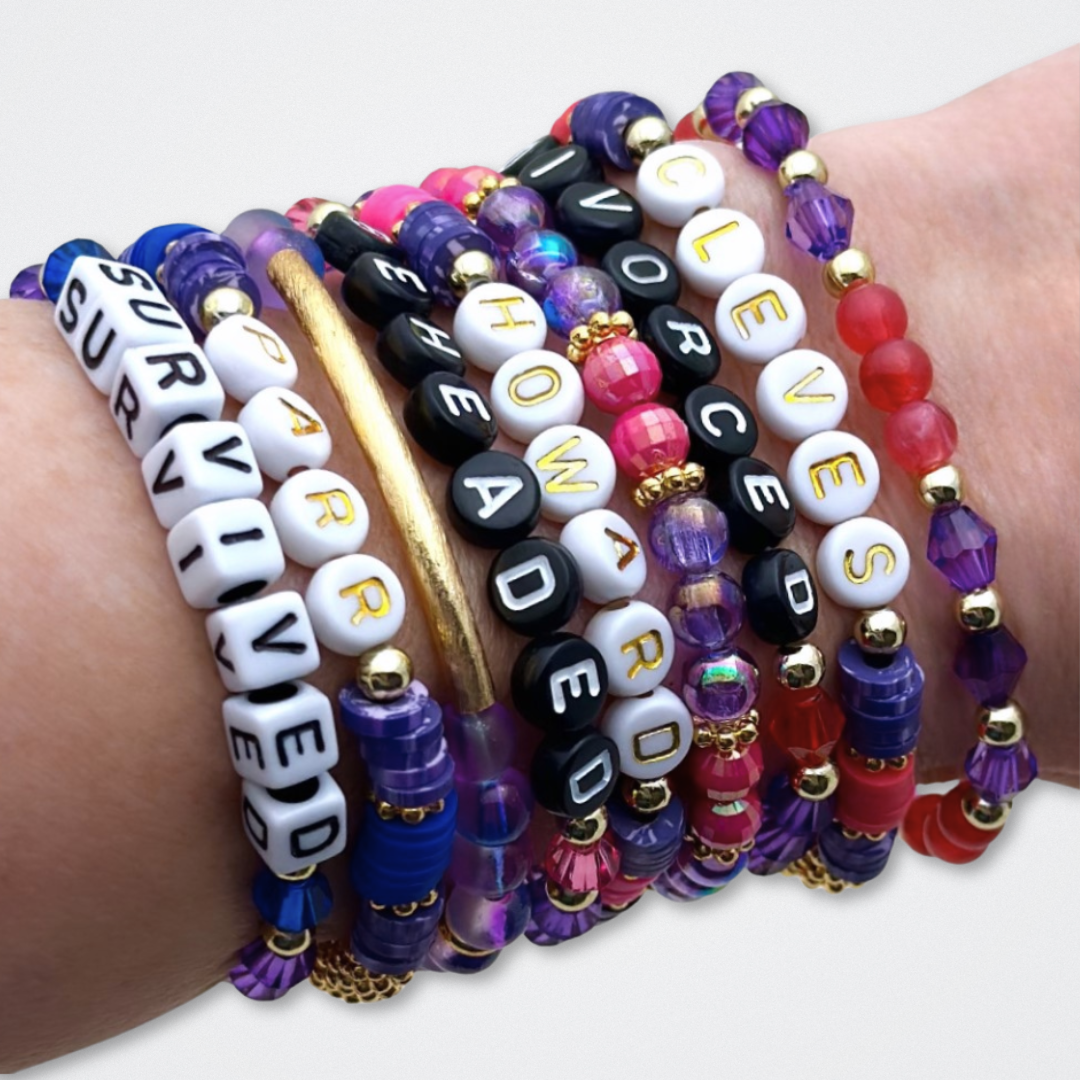Broadway Stacks QUEEN collection. Stretch bracelets included in Stack. Gold, yellow, green, white, red, pink and blue colored beads. Letter beads that spell each queen. Also Herstory collection. Broadway Stacks gold star logo bead to remind you that You Shine. SIX the Musical fans.