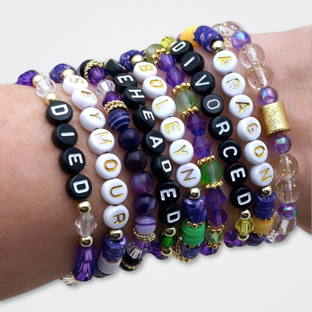 Broadway Stacks QUEEN collection. Stretch bracelets included in Stack. Gold, yellow, green, white, red, pink and blue colored beads. Letter beads that spell each queen. Also Herstory collection. Broadway Stacks gold star logo bead to remind you that You Shine. SIX the Musical fans.