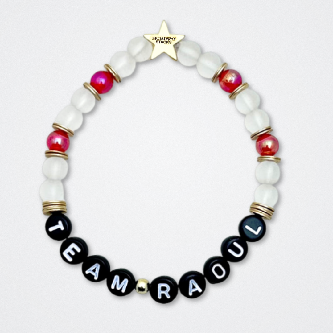 Broadway Stacks MASK collection. Bead bracelets included in Stack. Red, black, white and gold colored beads. Letter beads that spell quotes. Team Phantom, Team Christine, Team Raoul. Gold star logo bead to remind you that You Shine. Phantom of the Opera and Masquerade fans.