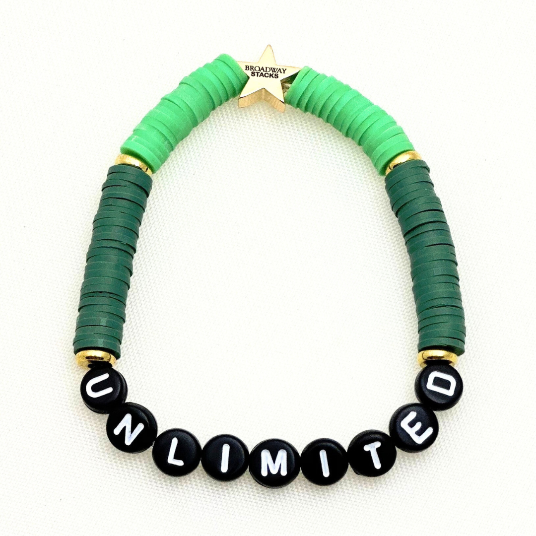 Broadway Stacks Witch collection. 3 stretch bracelets included in Stack. Greens, pinks, black and gold colored beads. Letter beads that spell Wicked. Gold star logo bead on every bracelet.
