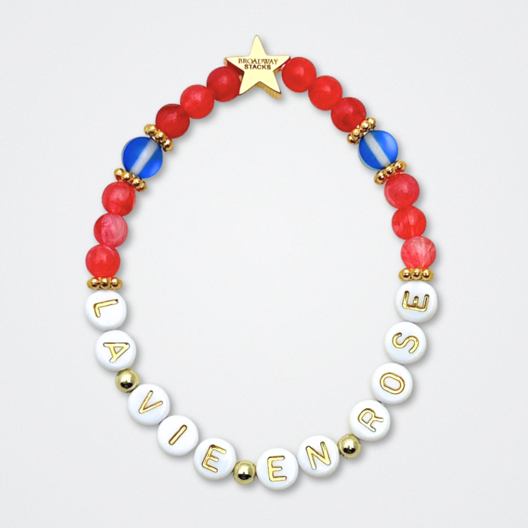 Broadway Stacks JAZZY Collection. 5 stretch bracelets included in Stack. Red, blue, black and gold colored beads. Letter beads that spell quotes. Gold star logo bead to remind you that you shine. Wonderful World musical and Louis Armstrong fans.
