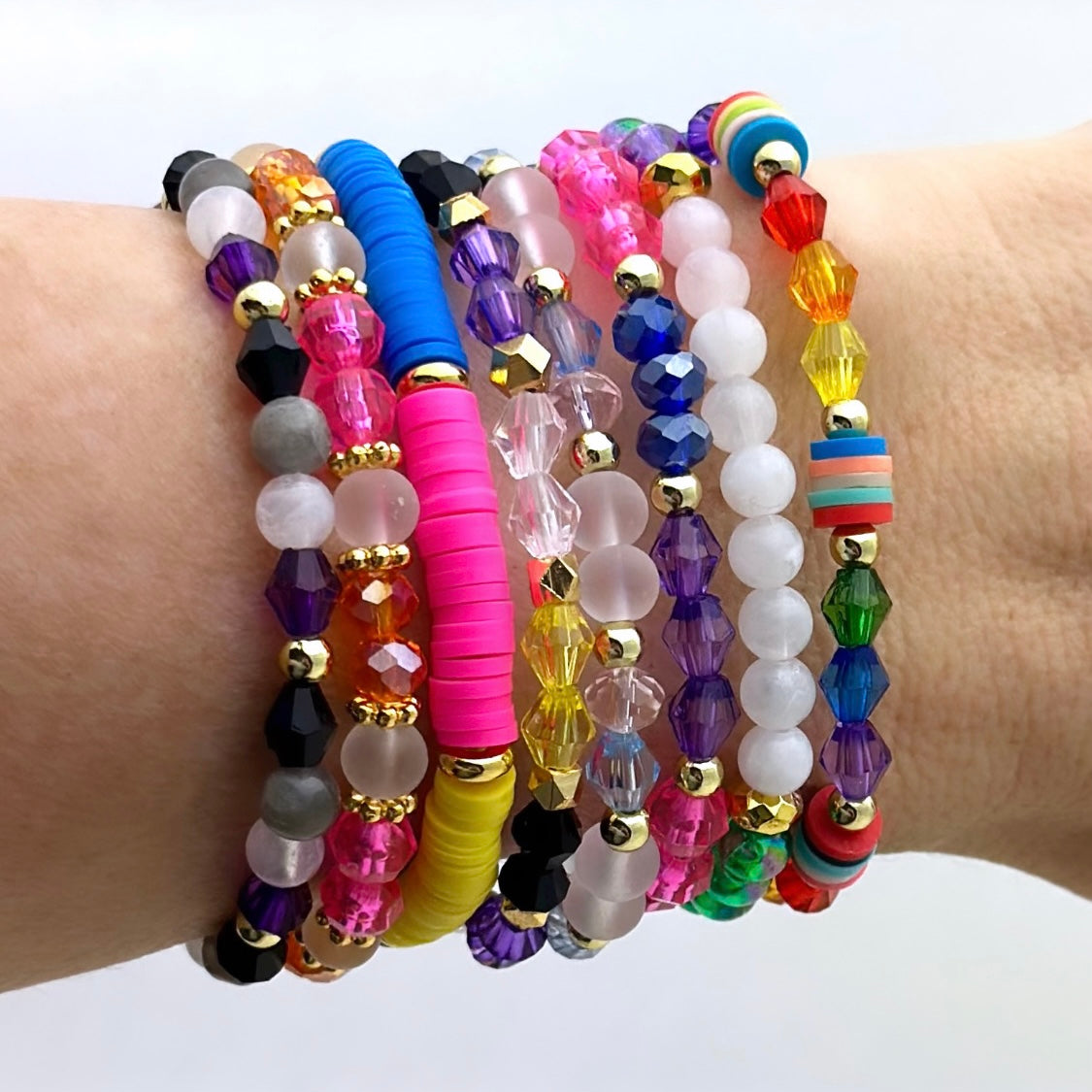 Broadway Stacks PRIDE collection. Avaliable in 8 designs. Red, orange, yellow, green, blue, purple, pink, white, grey, black and gold colored beads. Broadway Stacks gold star logo bead on back.