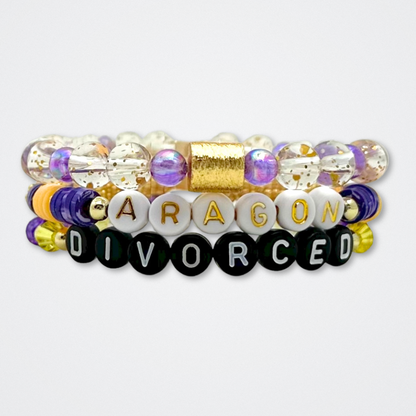 Broadway Stacks QUEEN collection. Stretch bracelets included in Stack. Gold, yellow, green, white, red, pink and blue colored beads. Letter beads that spell each queen. Also Herstory collection. Broadway Stacks gold star logo bead to remind you that You Shine. SIX the Musical fans.
