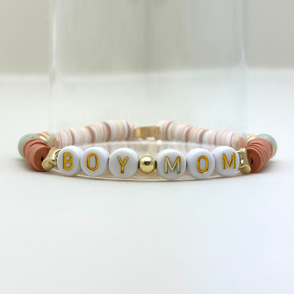Broadway Stacks Motherlode Special Edition bracelets. Stretch bracelets. Greens, browns, white and gold colored beads. Letter beads that spell Motherlode, Boy Mom, Girl Mom, Twin Mom,