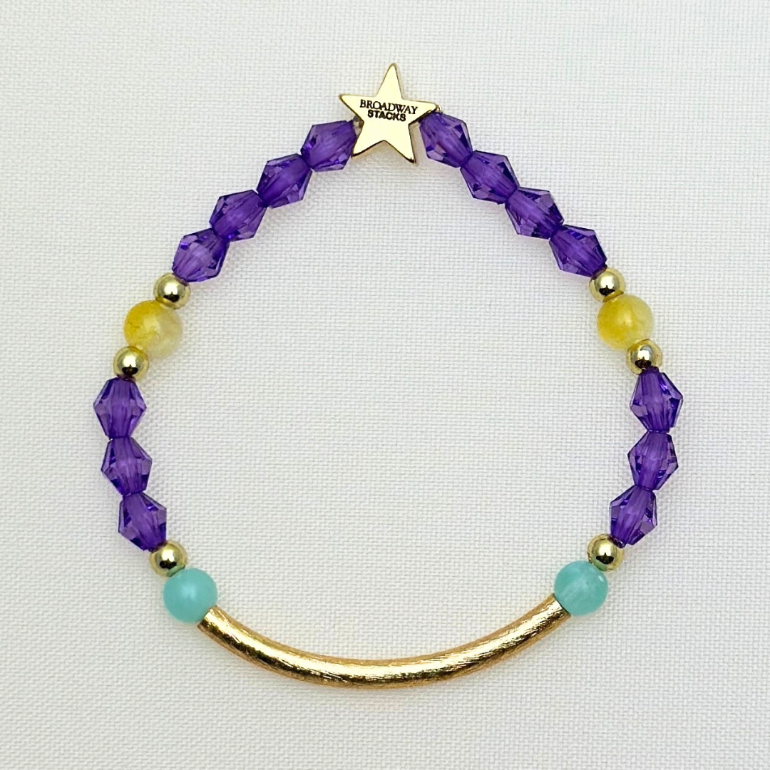 Suffs musical gold bar bead bracelet, purple, yellow, teal and gold beads, gold star logo bead of Broadway Stacks