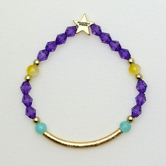 Suffs musical gold bar bead bracelet, purple, yellow, teal and gold beads, gold star logo bead of Broadway Stacks