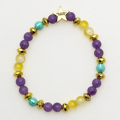 Suffs musical  bead bracelet, purple, yellow, teal and gold beads, gold star logo bead of Broadway Stacks