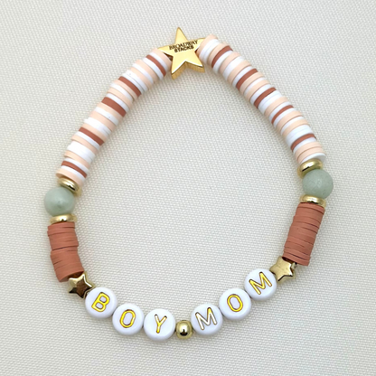 Broadway Stacks Motherlode Special Edition bracelets. Stretch bracelets. Greens, browns, white and gold colored beads. Letter beads that spell Motherlode, Boy Mom, Girl Mom, Twin Mom,