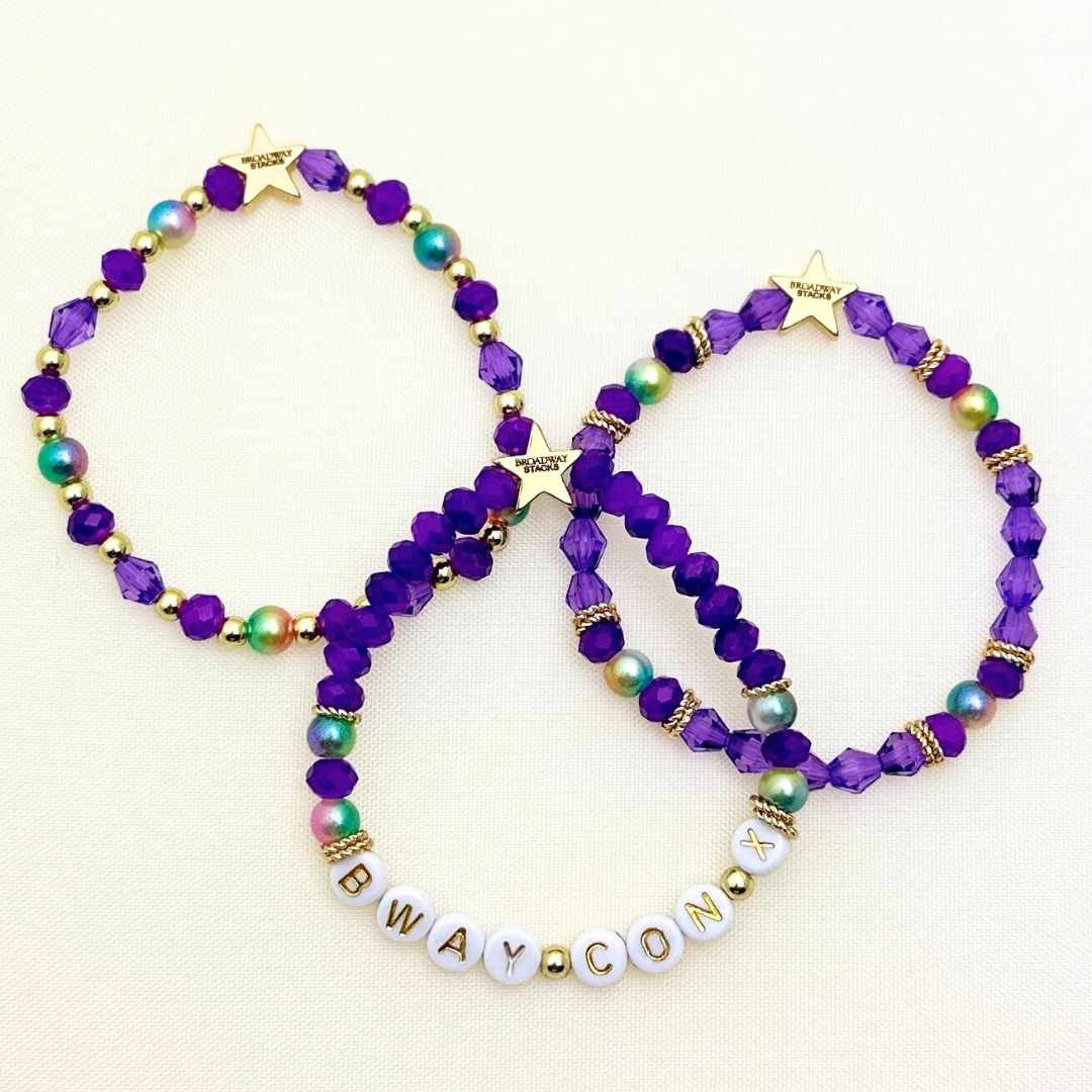 Broadway Stacks BroadwayCon X 2025 Special Edition bracelet. Stack of 3 bracelets. Purple, gold and iridescent colored beads. Letter beads that spell Bway Con X.