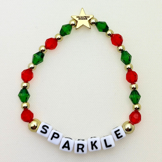 Broadway Stacks CHRISTMAS Collection. 4 stretch bracelets included in Stack. Red, green, white and gold colored beads. Letter beads that spell quotes. Gold star logo bead to remind you that you shine.