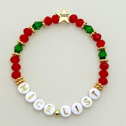 Broadway Stacks CHRISTMAS Collection. 5 stretch bracelets included in Stack. Red, green, white and gold colored beads. Letter beads that spell quotes. Gold star logo bead to remind you that you shine.