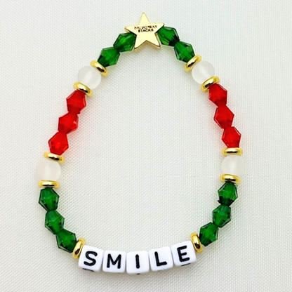 Broadway Stacks CHRISTMAS Collection. 5 stretch bracelets included in Stack. Red, green, white and gold colored beads. Letter beads that spell quotes. Gold star logo bead to remind you that you shine.