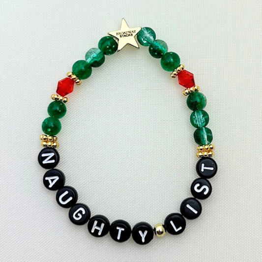 Broadway Stacks CHRISTMAS Collection. 5 stretch bracelets included in Stack. Red, green, white and gold colored beads. Letter beads that spell quotes. Gold star logo bead to remind you that you shine.