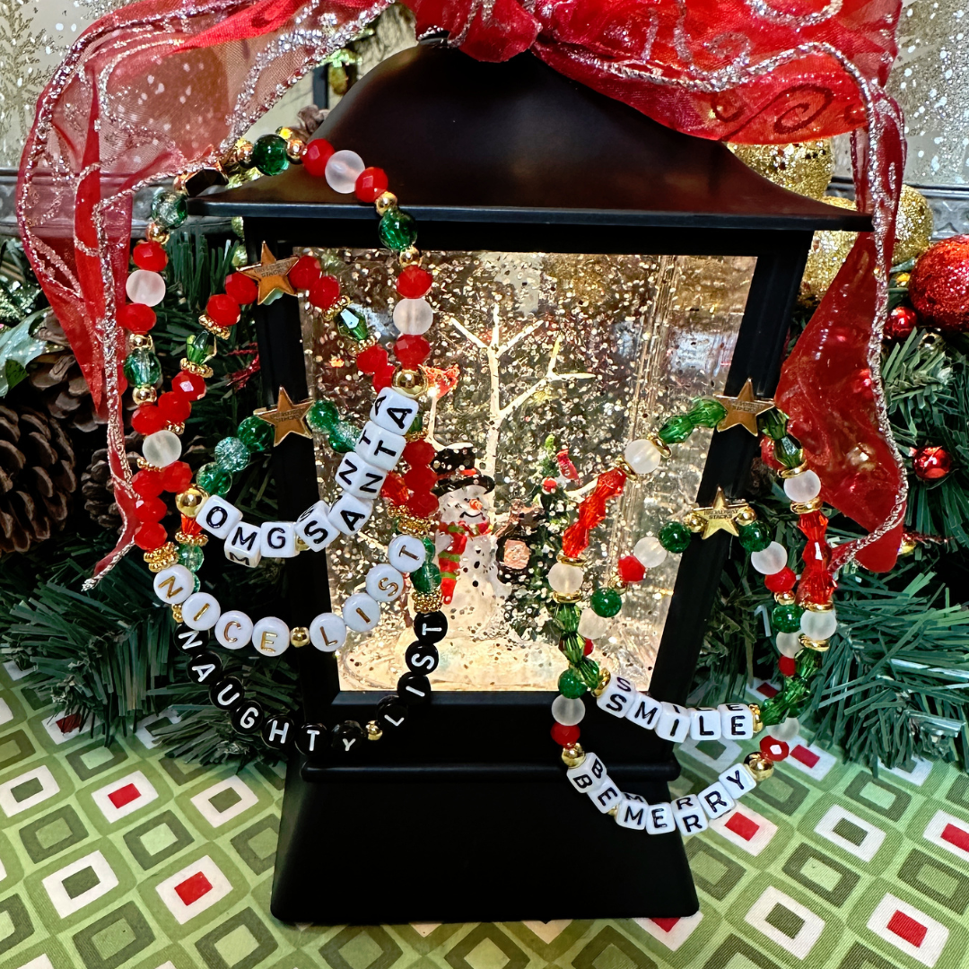 Broadway Stacks CHRISTMAS Collection. 5 stretch bracelets included in Stack. Red, green, white and gold colored beads. Letter beads that spell quotes. Gold star logo bead to remind you that you shine.