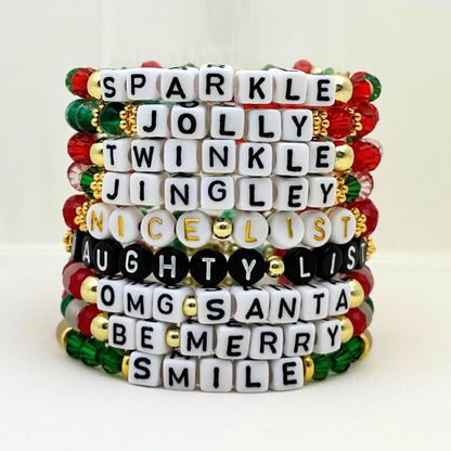 Broadway Stacks CHRISTMAS Collection. 9 stretch bracelets included in Stack. Red, green, white and gold colored beads. Letter beads that spell quotes. Gold star logo bead to remind you that you shine.