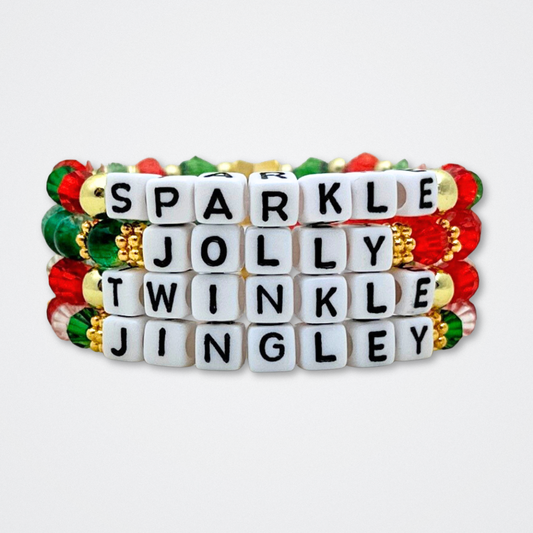 Broadway Stacks CHRISTMAS ELF Collection. Coordinating bead bracelets included in Stack. Red, green, white and gold colored beads. Letter beads that spell quotes. Gold star logo bead to remind you that you shine. Elf the Musical and Christmas holiday fans.