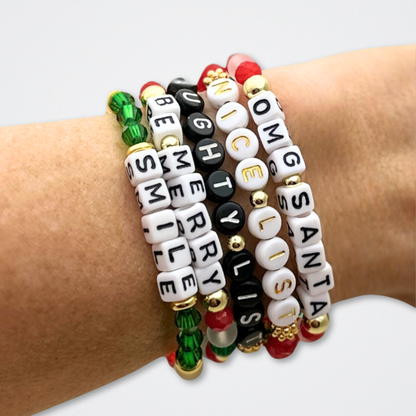 Broadway Stacks CHRISTMAS ELF Collection. Coordinating bead bracelets included in Stack. Red, green, white and gold colored beads. Letter beads that spell quotes. Gold star logo bead to remind you that you shine. Elf the Musical and Christmas holiday fans.
