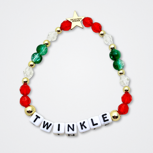 Broadway Stacks CHRISTMAS ELF Collection. Coordinating bead bracelets included in Stack. Red, green, white and gold colored beads. Letter beads that spell quotes. Gold star logo bead to remind you that you shine. Elf the Musical and Christmas holiday fans.