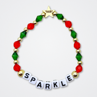 Broadway Stacks CHRISTMAS ELF Collection. Coordinating bead bracelets included in Stack. Red, green, white and gold colored beads. Letter beads that spell quotes. Gold star logo bead to remind you that you shine. Elf the Musical and Christmas holiday fans.