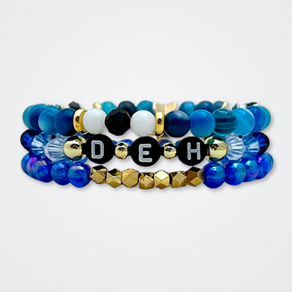 Broadway Stacks SKY collection. 3 stretch bracelets included in Stack. Blues, white, black and gold colored beads. Letter beads that spell quotes. Gold star logo bead to remind you that You Shine. Dear Evan Hansen DEH fans.