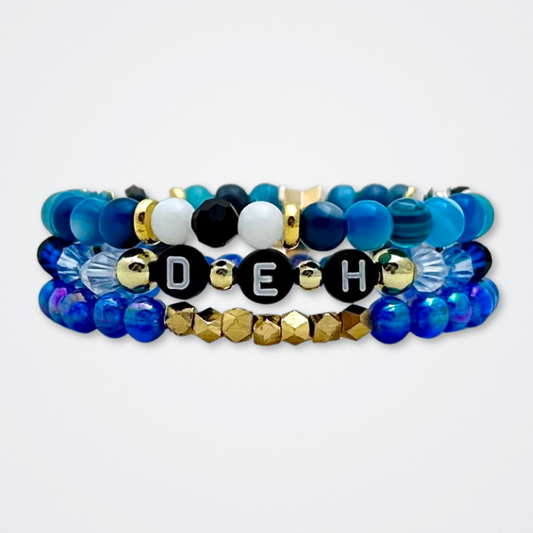 Broadway Stacks SKY collection. 3 stretch bracelets included in Stack. Blues, white, black and gold colored beads. Letter beads that spell quotes. Gold star logo bead to remind you that You Shine. Dear Evan Hansen DEH fans.