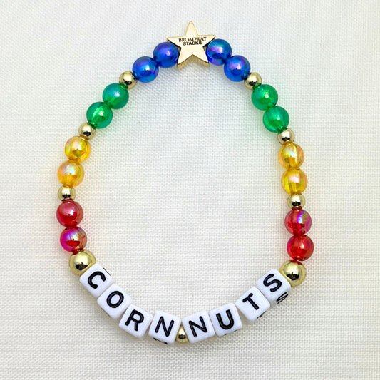 Broadway Stacks CORN NUTS Collection. 5 stretch bracelets included in Stack. Red, yellow, green, blue, black and gold colored beads. Letter beads that spell quotes. Gold star logo bead to remind you that you shine. Heathers the Musical fans.