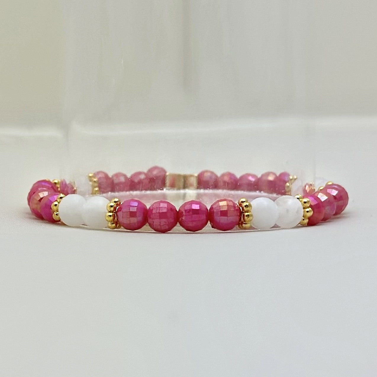 Broadway Stacks POTUS collection. 3 stretch bracelets included in Stack. Pinks, white, blue, golds and black colored beads. Letter beads that spell show quotes. Broadway Stacks gold star logo bead on back.