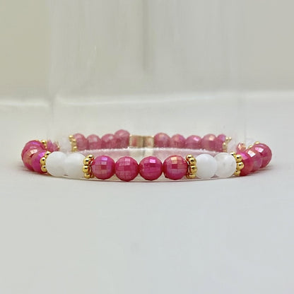 Broadway Stacks POTUS collection. 3 stretch bracelets included in Stack. Pinks, white, blue, golds and black colored beads. Letter beads that spell show quotes. Broadway Stacks gold star logo bead on back.