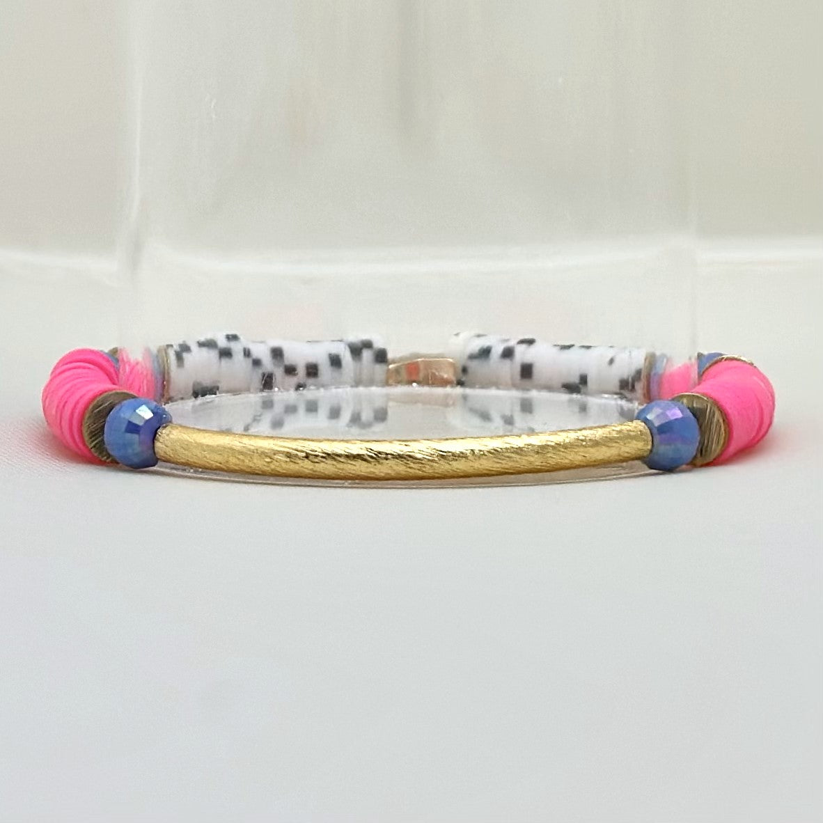 Broadway Stacks POTUS collection. 3 stretch bracelets included in Stack. Pinks, white, blue, golds and black colored beads. Letter beads that spell show quotes. Broadway Stacks gold star logo bead on back.