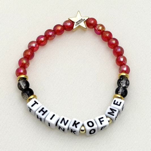 Broadway Stacks MASK collection. 3 stretch bracelets included in Stack. Red, white, gold and black colored beads. Letter beads that spell show quotes. Broadway Stacks gold star logo bead on back.