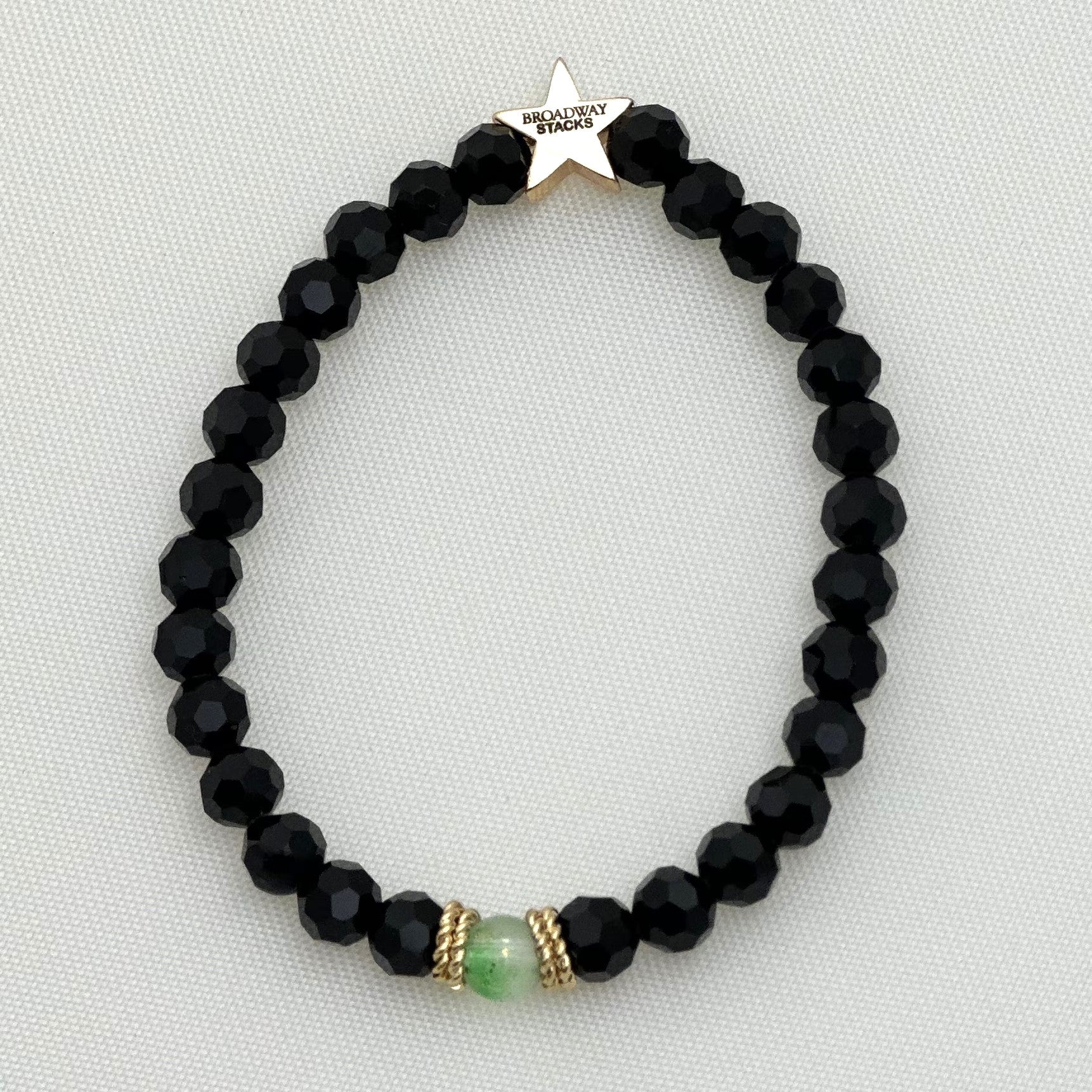 Broadway Stacks WITCH collection. 3 stretch bracelets included in Stack. Greens, white, pinks, gold and black colored beads. Letter beads that spell show quotes. Broadway Stacks gold star logo bead on back.