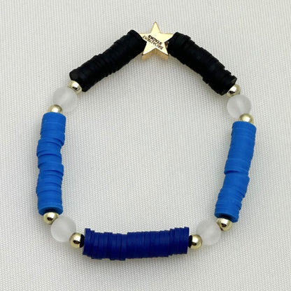 Broadway Stacks SKY collection. 3 stretch bracelets included in Stack. Blues, white, clear, gold and black colored beads. Letter beads that spell show quotes. Broadway Stacks gold star logo bead on back.