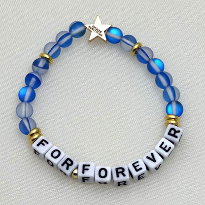 Broadway Stacks SKY collection. 3 stretch bracelets included in Stack. Blues, white, clear, gold and black colored beads. Letter beads that spell show quotes. Broadway Stacks gold star logo bead on back.