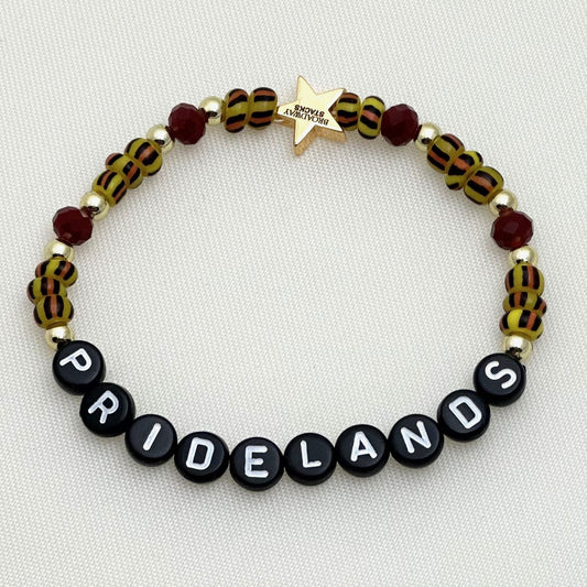 Broadway Stacks SAFARI collection. 3 stretch bracelets included in Stack. Reds, oranges, yellows, black, gold and animal print colored beads. Letter beads that spell show quotes. Broadway Stacks gold star logo bead on back.