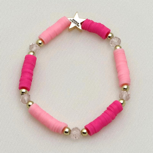 Broadway Stacks KEEP IT POSITIVE collection. 3 stretch bracelets included in Stack. Pinks, white, and gold colored beads. Letter beads that spell show quotes. Broadway Stacks gold star logo bead on back.