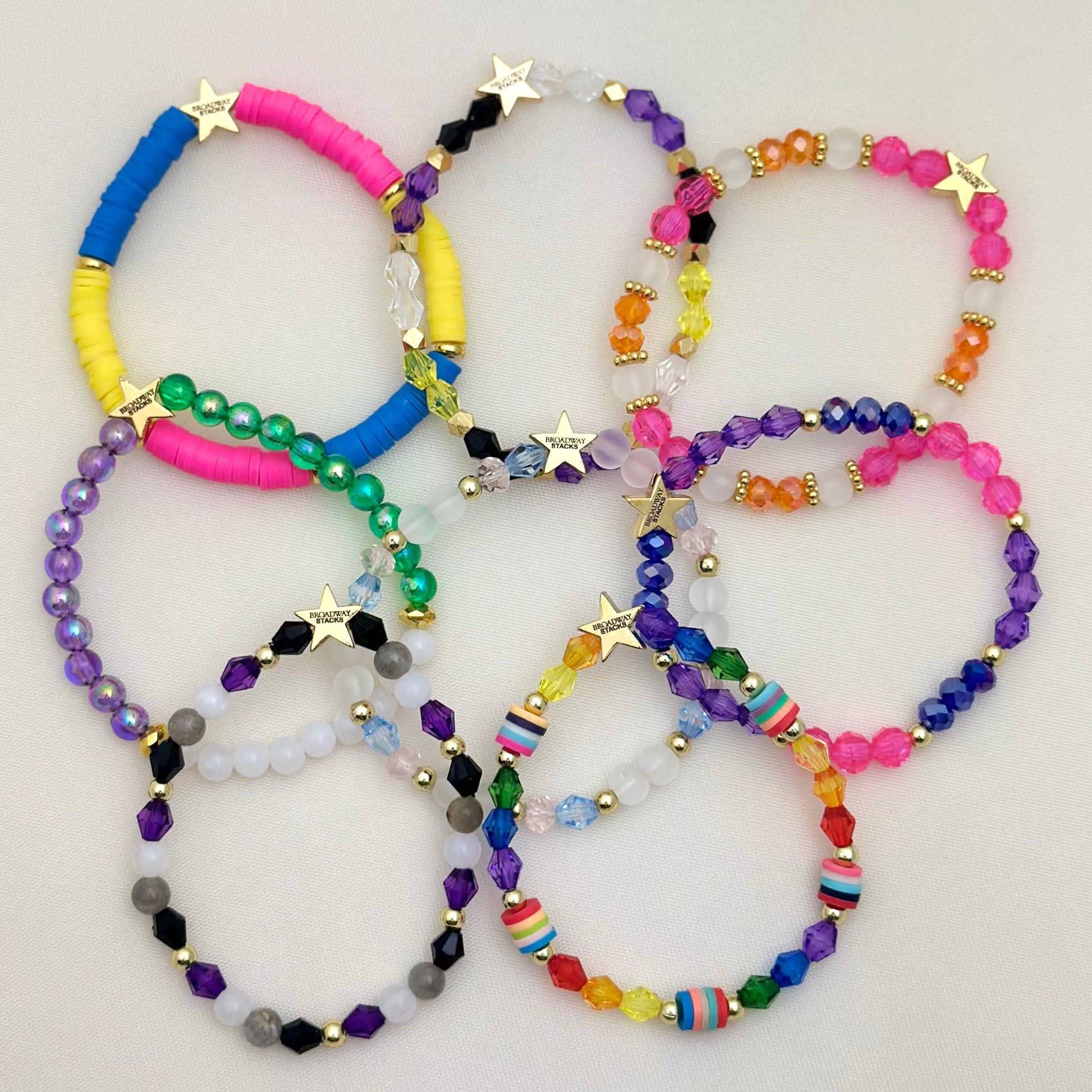 Broadway Stacks PRIDE collection. Avaliable in 8 designs. Red, orange, yellow, green, blue, purple, pink, white, grey, black and gold colored beads. Broadway Stacks gold star logo bead on back.