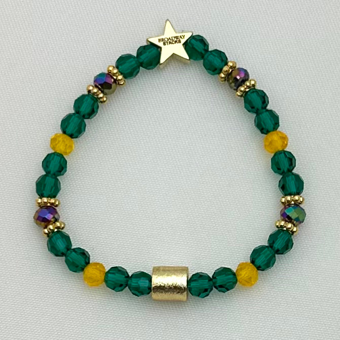 Broadway Stacks STAY GOLD collection. Stretch bracelets included in Stack. Gold, yellow, green and grey colored beads. Letter beads that have show quote or name. Broadway Stacks gold star logo bead on back.