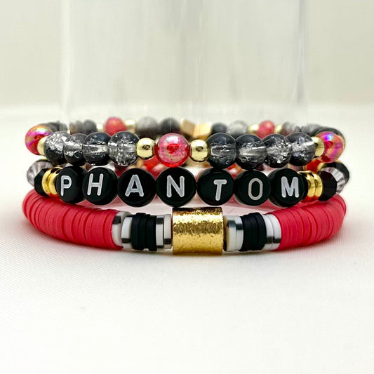 Broadway Stacks Phantom collection. 3 stretch bracelets included in Stack. Red, black, white and gold colored beads. Letter beads that spell Phantom.