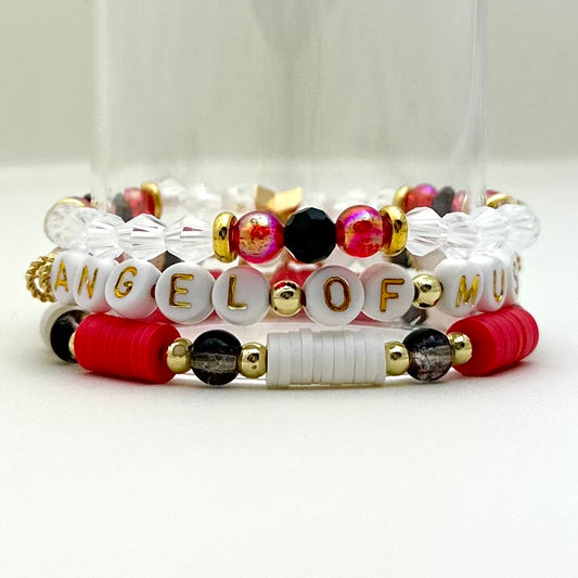 Broadway Stacks Phantom collection. 3 stretch bracelets included in Stack. Red, black, white and gold colored beads. Letter beads that spell Angel Of Music.