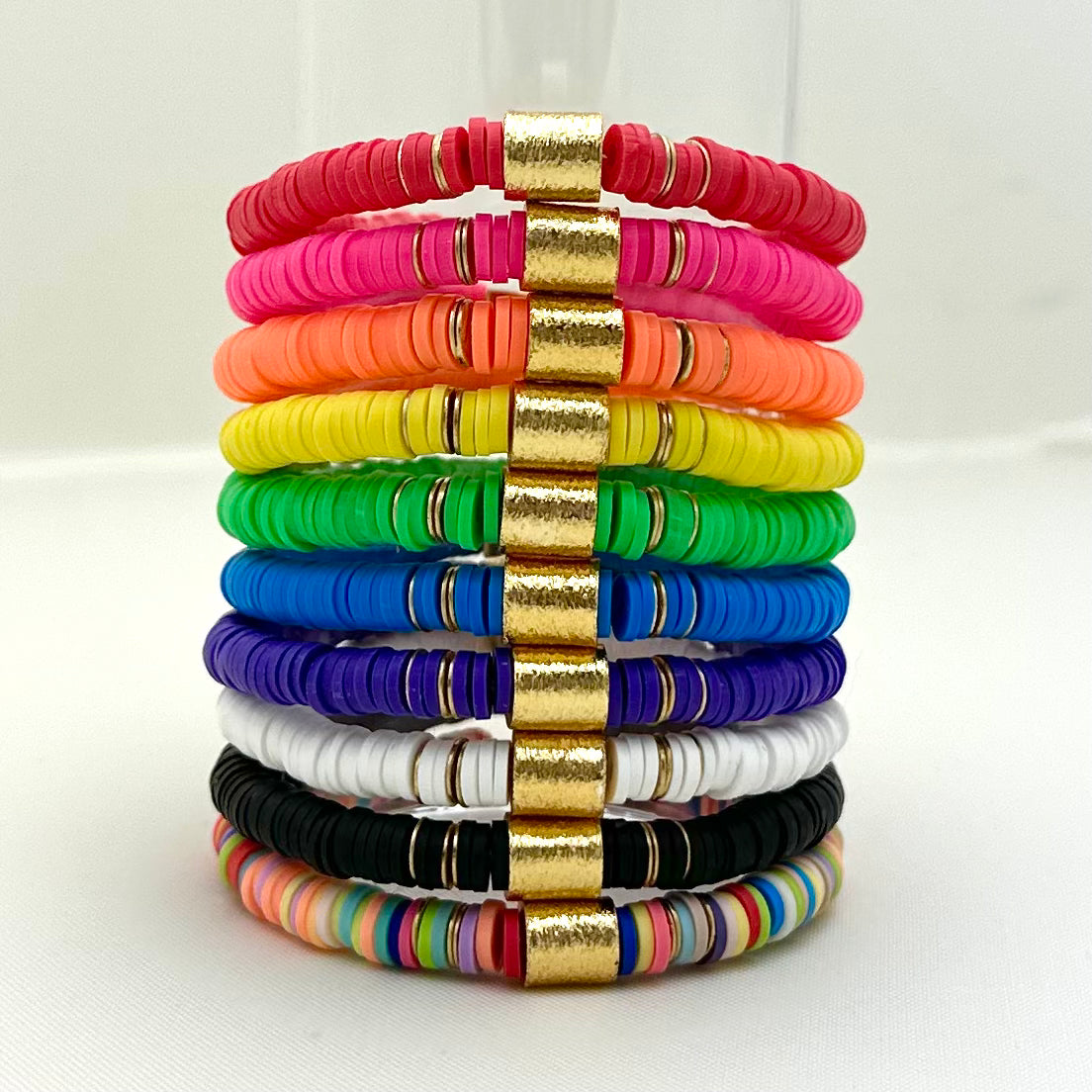 Broadway Stacks rainbow colors elastic stretch bracelets with gold color accents. Gold star logo bead that says Broadway Stacks. Available in red pink orange yellow green blue purple white black and mulit-color.