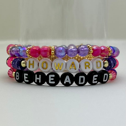 Broadway Stacks QUEEN collection. Stretch bracelets included in Stack. Gold, yellow, green, white, red, pink and blue colored beads. Letter beads that spell each queen. Also Herstory collection. Broadway Stacks gold star logo bead on back.