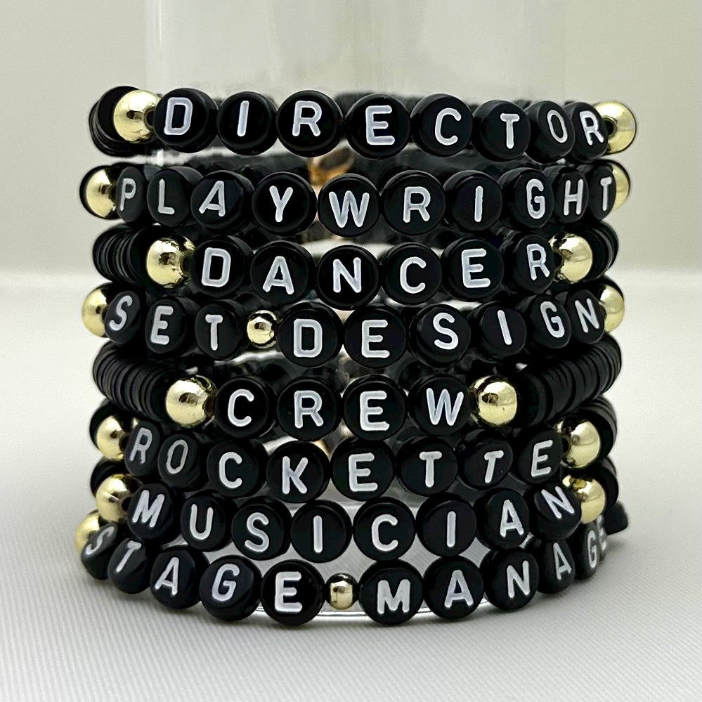 Broadway Stacks SPOTLIGHT Collection. Handcrafted beaded elastic-stretch bracelet with letter beads. Available in many varieties of theatre positions like actor, singer, dancer, director, stage manager, understudy, bway lover, crew, musician, etc. Gold color accents. Available in black, white and mulit-color. Broadway Stacks gold star logo bead on back.