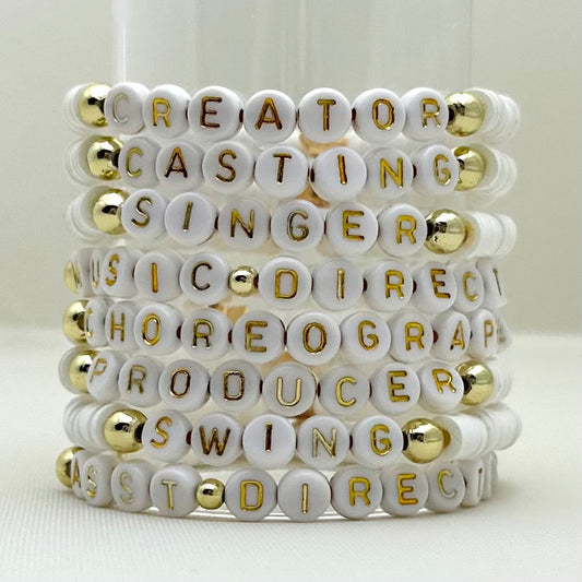 Broadway Stacks SPOTLIGHT Collection. Handcrafted beaded elastic-stretch bracelet with letter beads. Available in many varieties of theatre positions like actor, singer, dancer, director, stage manager, understudy, bway lover, crew, musician, etc. Gold color accents. Available in black, white and mulit-color. Broadway Stacks gold star logo bead on back.