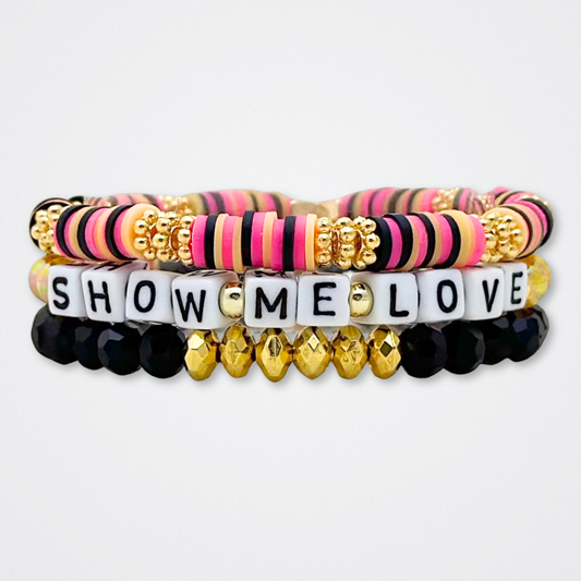 Broadway Stacks De Bois Band collection. 3 stretch bracelets included in Stack. Pinks, golds and black colored beads. Letter beads that spell quotes. Broadway Stacks gold star logo bead to remind you that you shine. & Juliet fans.