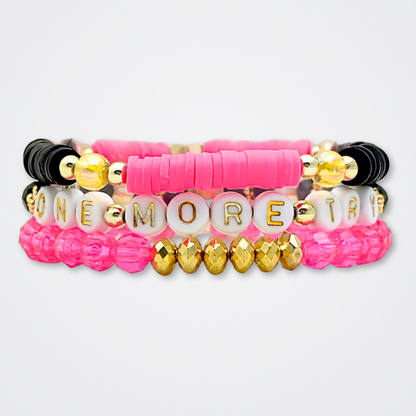 Broadway Stacks De Bois Band collection. 3 stretch bracelets included in Stack. Pinks, golds and black colored beads. Letter beads that spell quotes. Broadway Stacks gold star logo bead to remind you that you shine. & Juliet fans.
