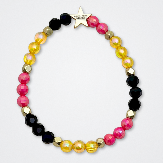Broadway Stacks De Bois Band collection. 3 stretch bracelets included in Stack. Pinks, golds and black colored beads. Letter beads that spell quotes. Broadway Stacks gold star logo bead to remind you that you shine. & Juliet fans.