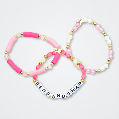 Broadway Stacks KEEP IT POSITIVE Collection. 9 stretch bracelets included in Stack. Pinks, white and gold colored beads. Letter beads that spell quotes. Gold star logo bead to remind you that you shine. Legally Blonde fans. 