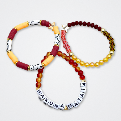 Broadway Stacks SAFARI collection. 3 stretch bracelets included in Stack. Dark reds, yellow, orange, white, black and gold colored beads. Animal print beads as well. Letter beads that spell quotes, Gold star logo bead to remind you that you shine.